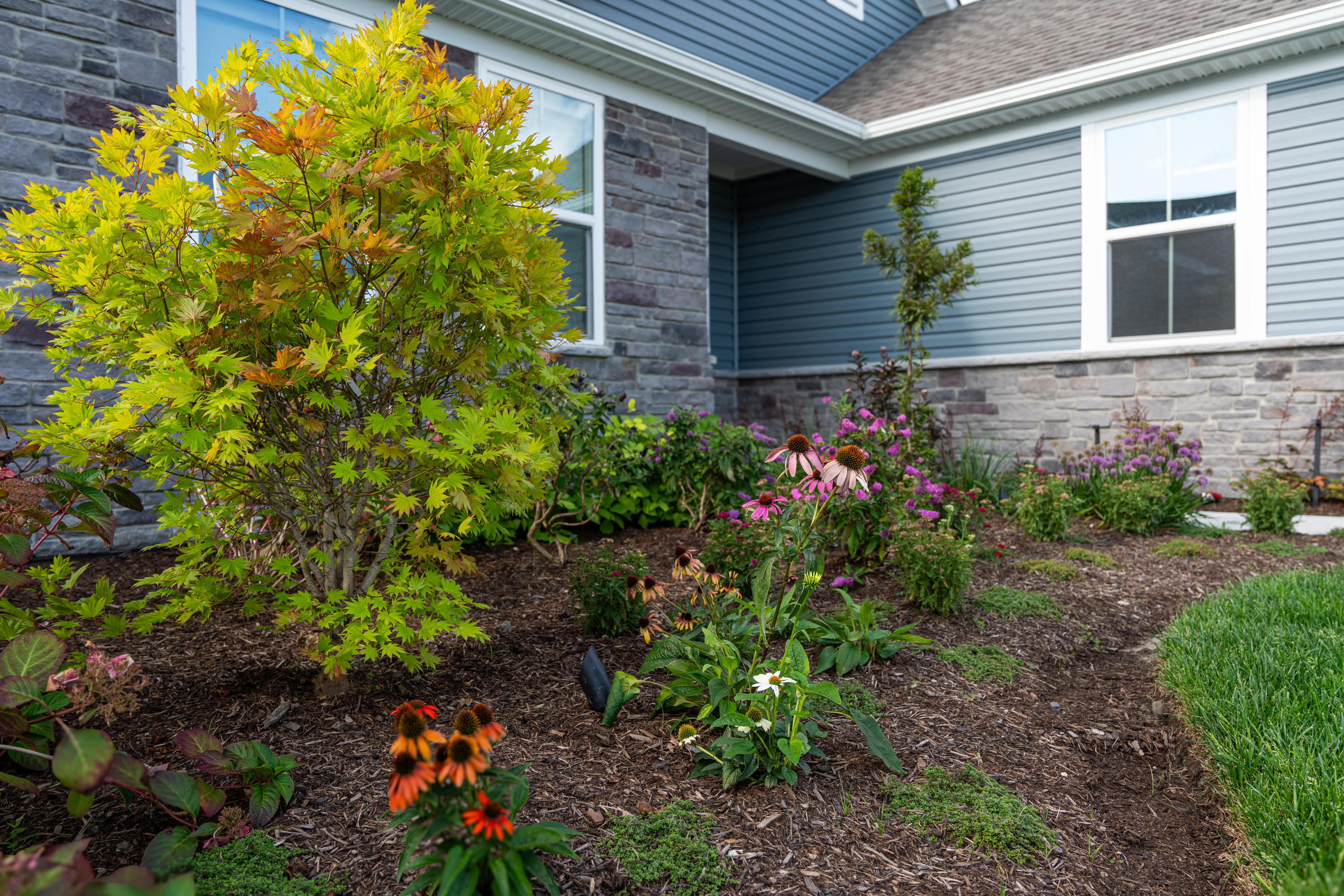 Multi-level stone patio construction at Padre Pio Residence