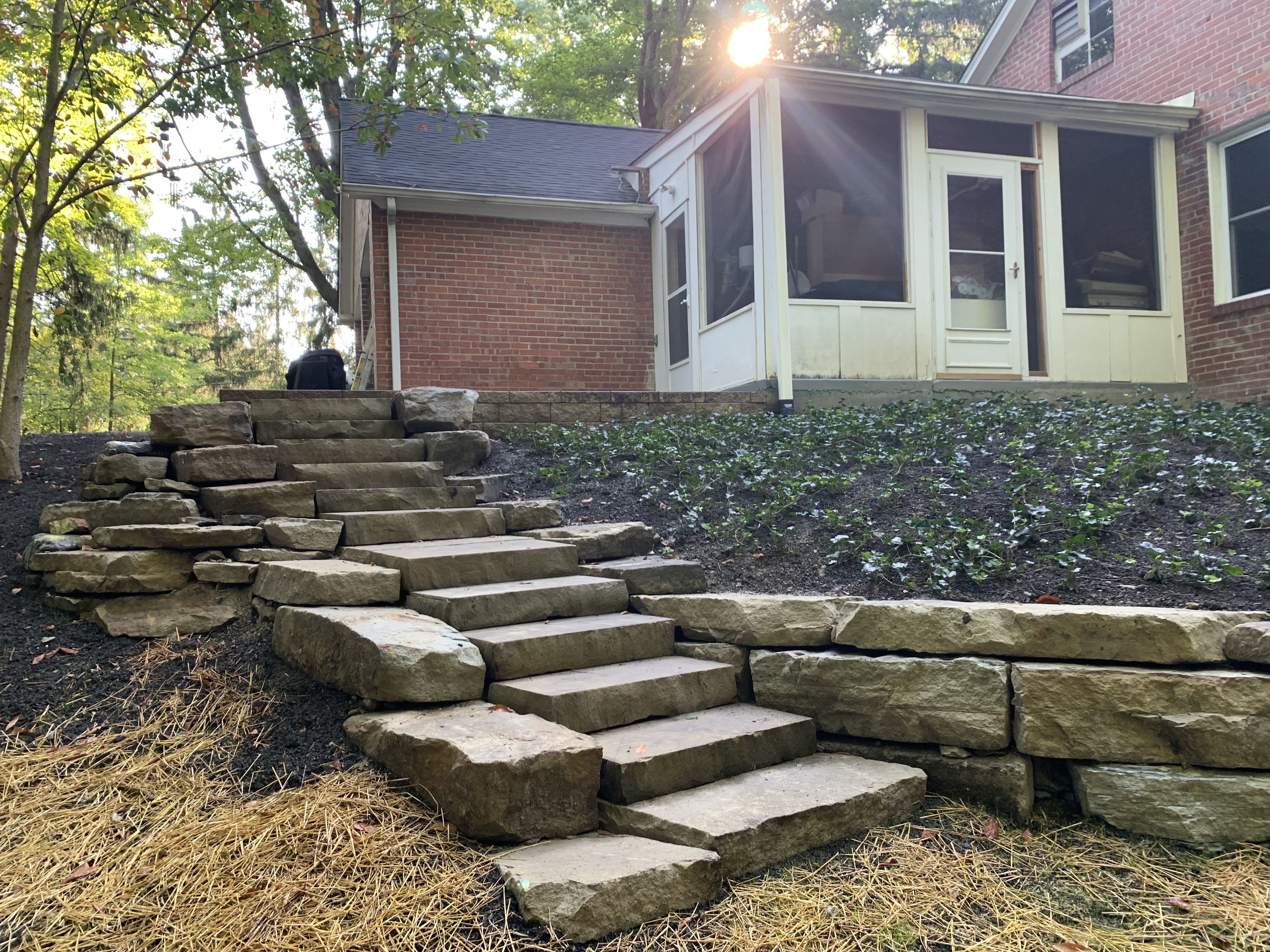 Custom hardscape patio and retaining wall by Moreno Landscaping
